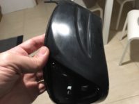 Parte da proteção frontal do capacete já limpa da tinta borrachosa